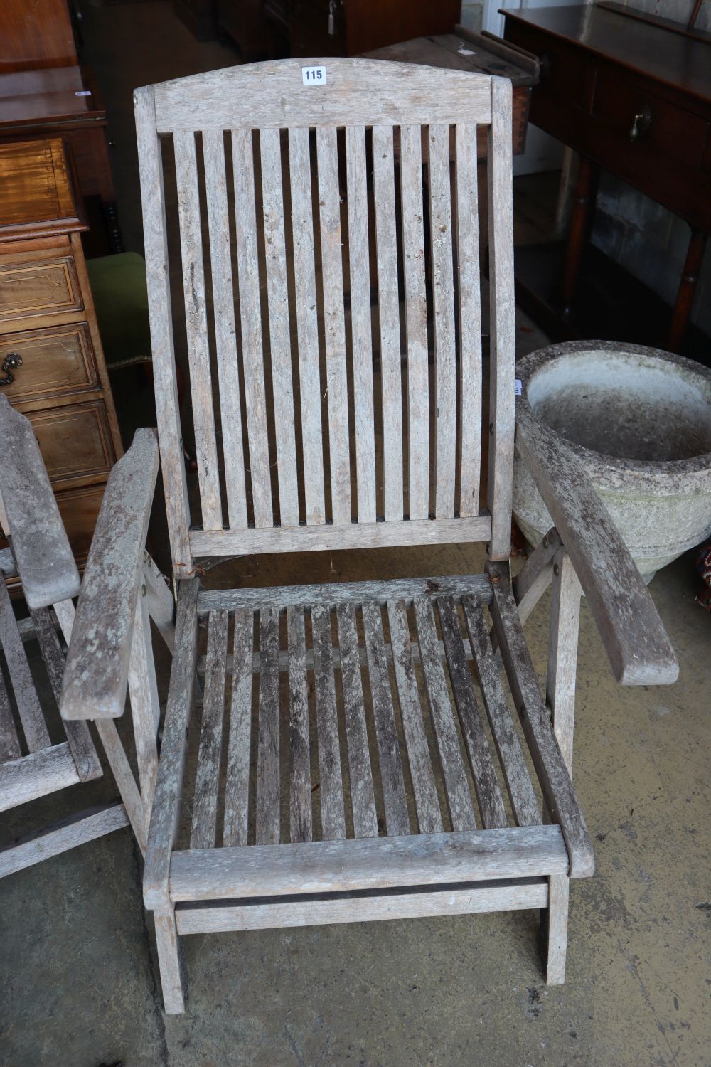 A pair of weathered teak folding garden chairs and a similar steamer chair